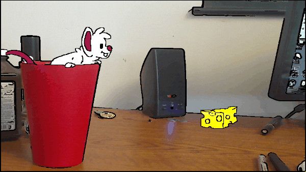 A cartoon mouse composited into a real cup on a desk