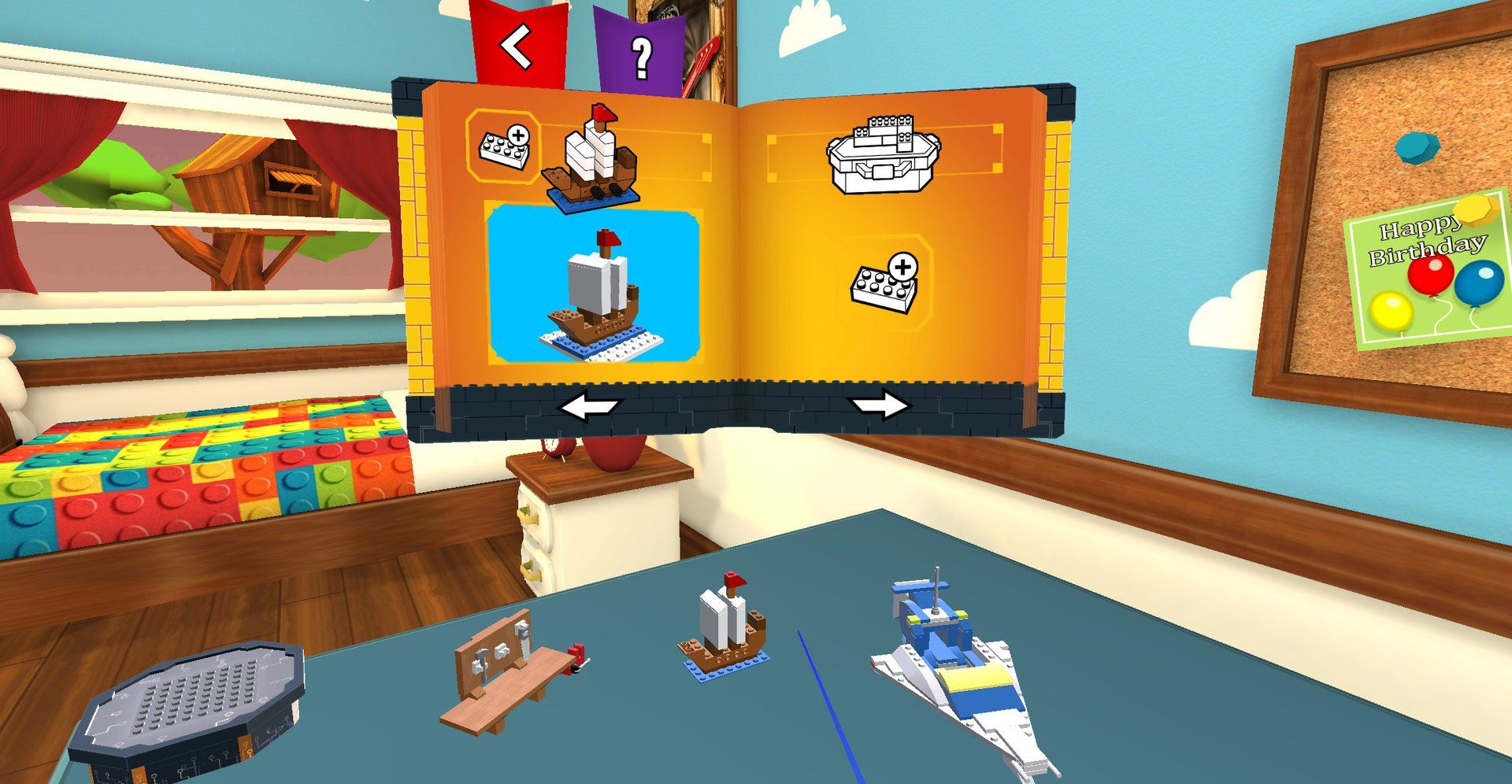 A finished pirate ship and space shuttle on the play mat beside the challenge book